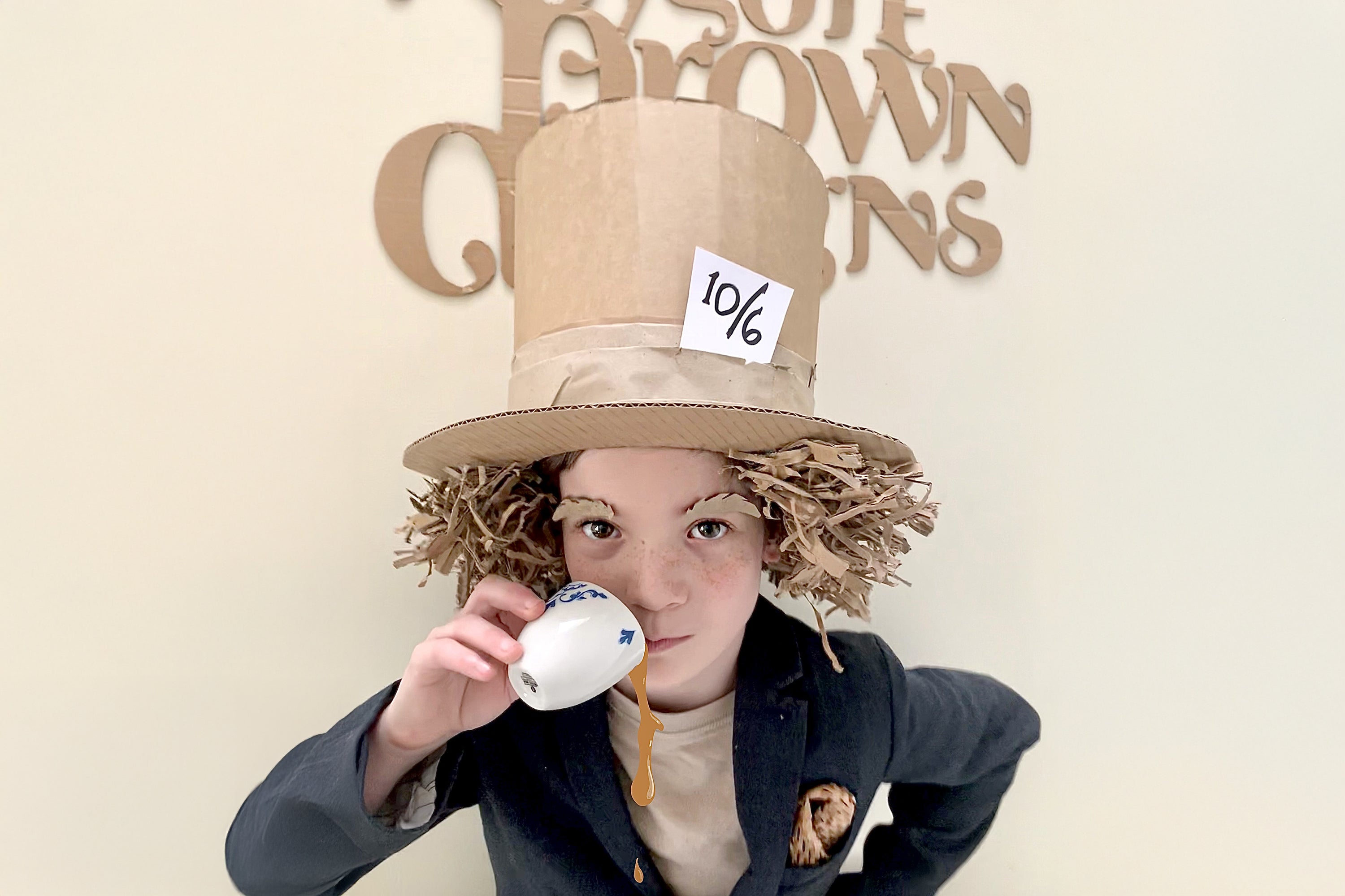 Child dressed up for Book week dress as the Mad Hatter with a cardboard hat and packaging