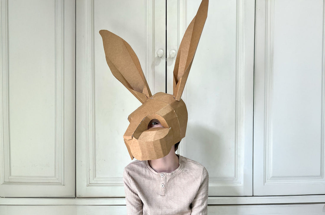 Child dressed up as a bunny rabbit with a cardboard made mask