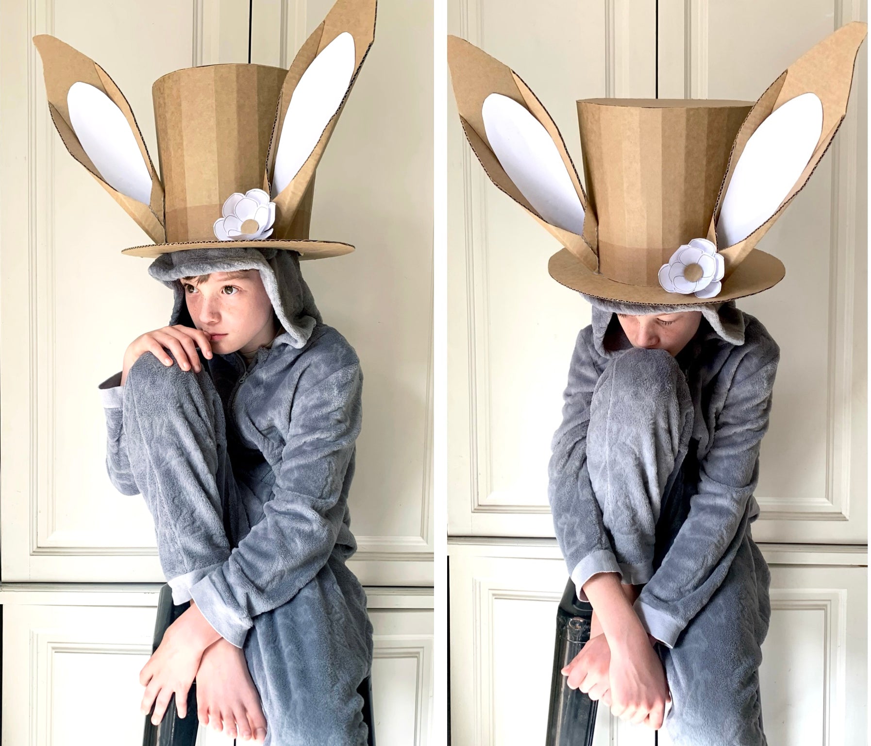 Person wearing a cardboard bunny hat with ears and a flower in front of paneled walls.