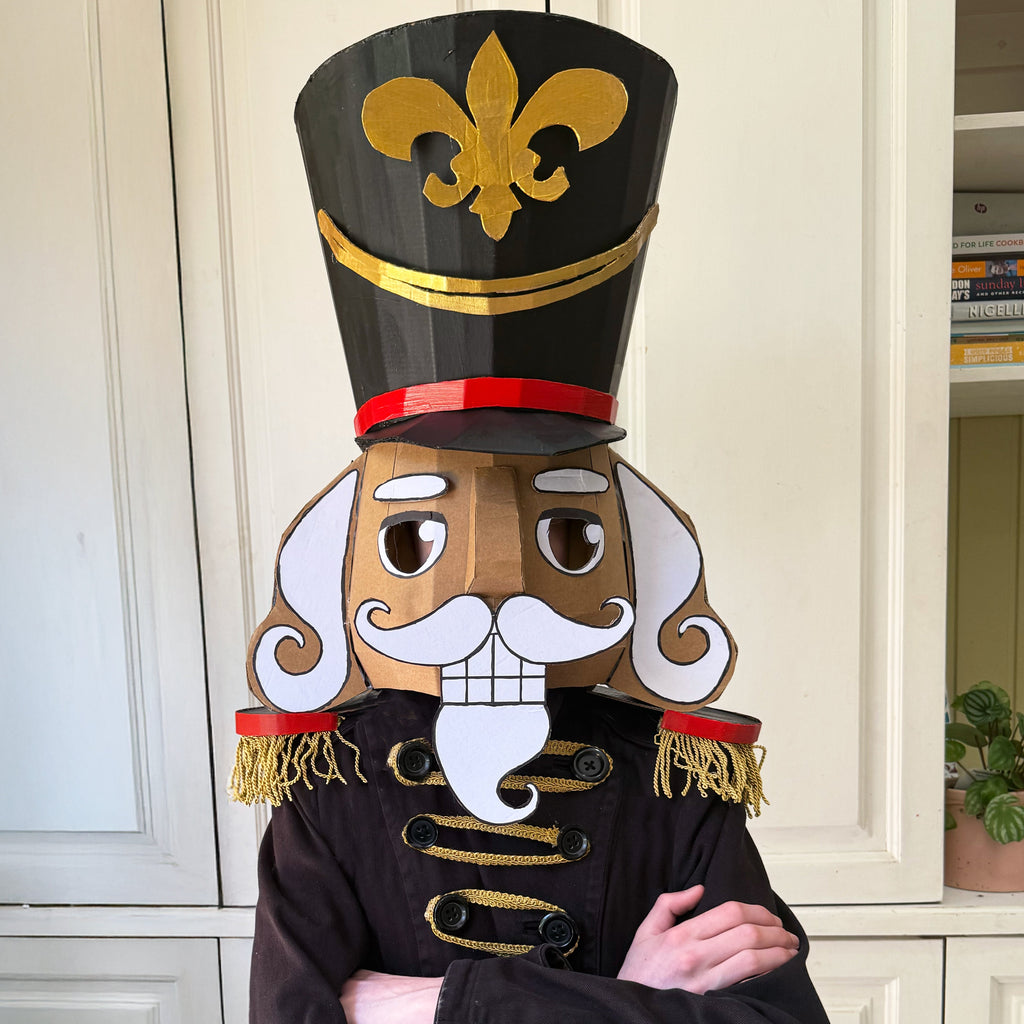 Painted cardboard nutcracker costume with white background
