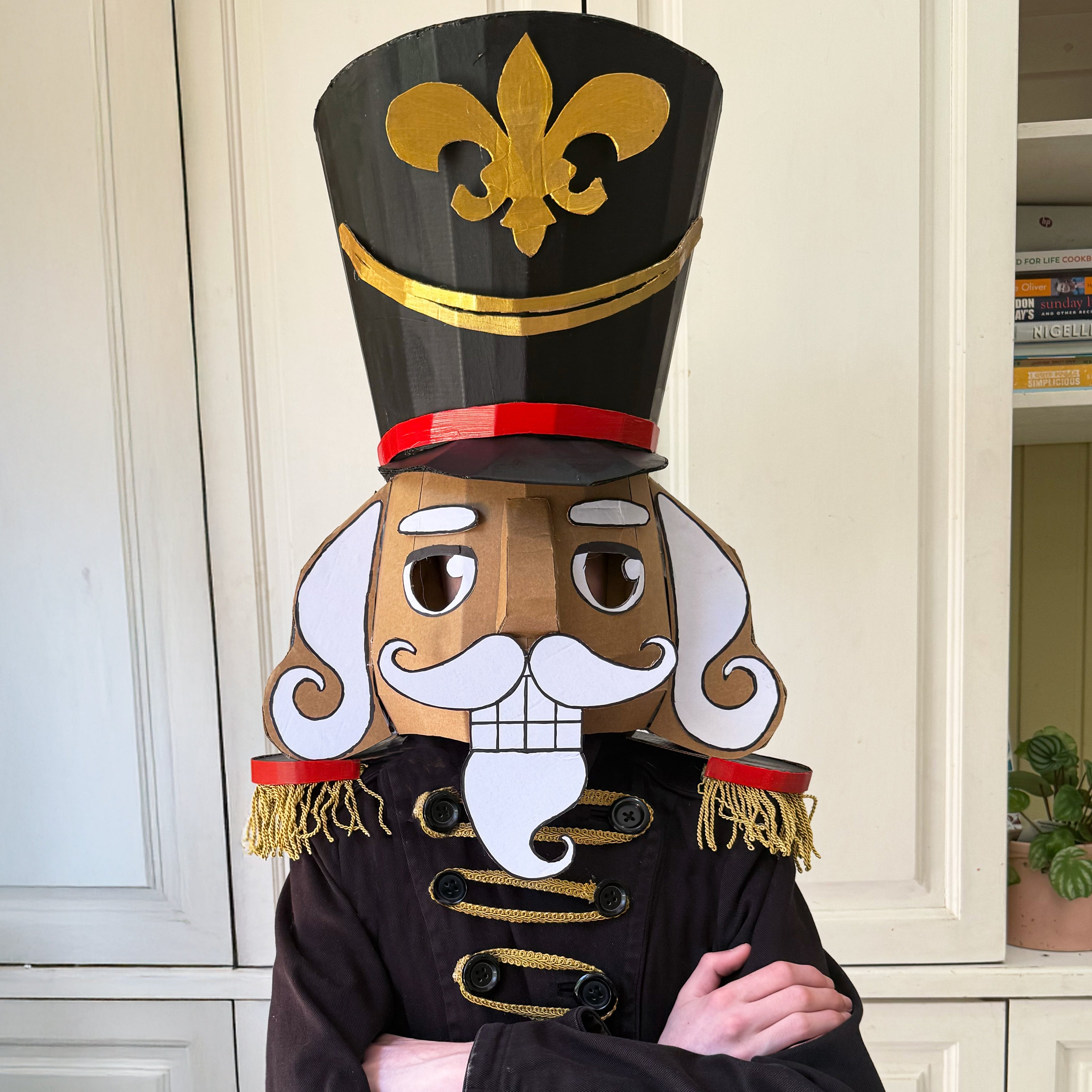 Painted cardboard nutcracker costume with white background
